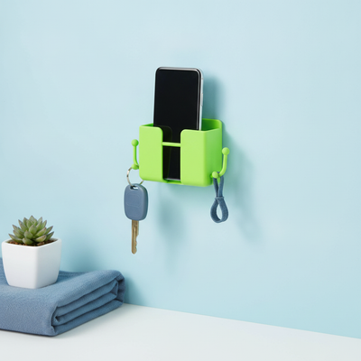 Neon green wall-mount mobile stand with hook, holding a smartphone against a soft blue wall.