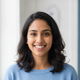 Portrait of a smiling South Asian woman, casually dressed, with a happy and trustworthy expression.